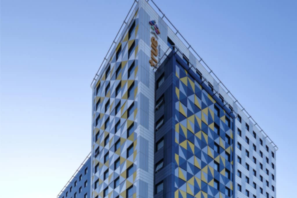 new student accommodation building in salford with blue sky behind