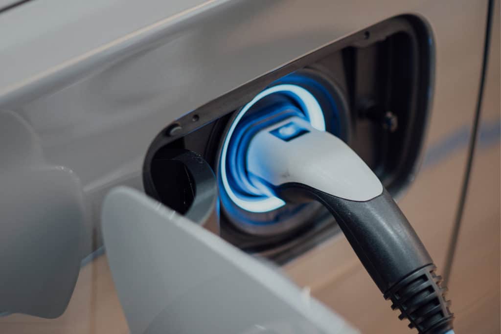 Electric Vehicle Charging Port on a car with charger plugged in