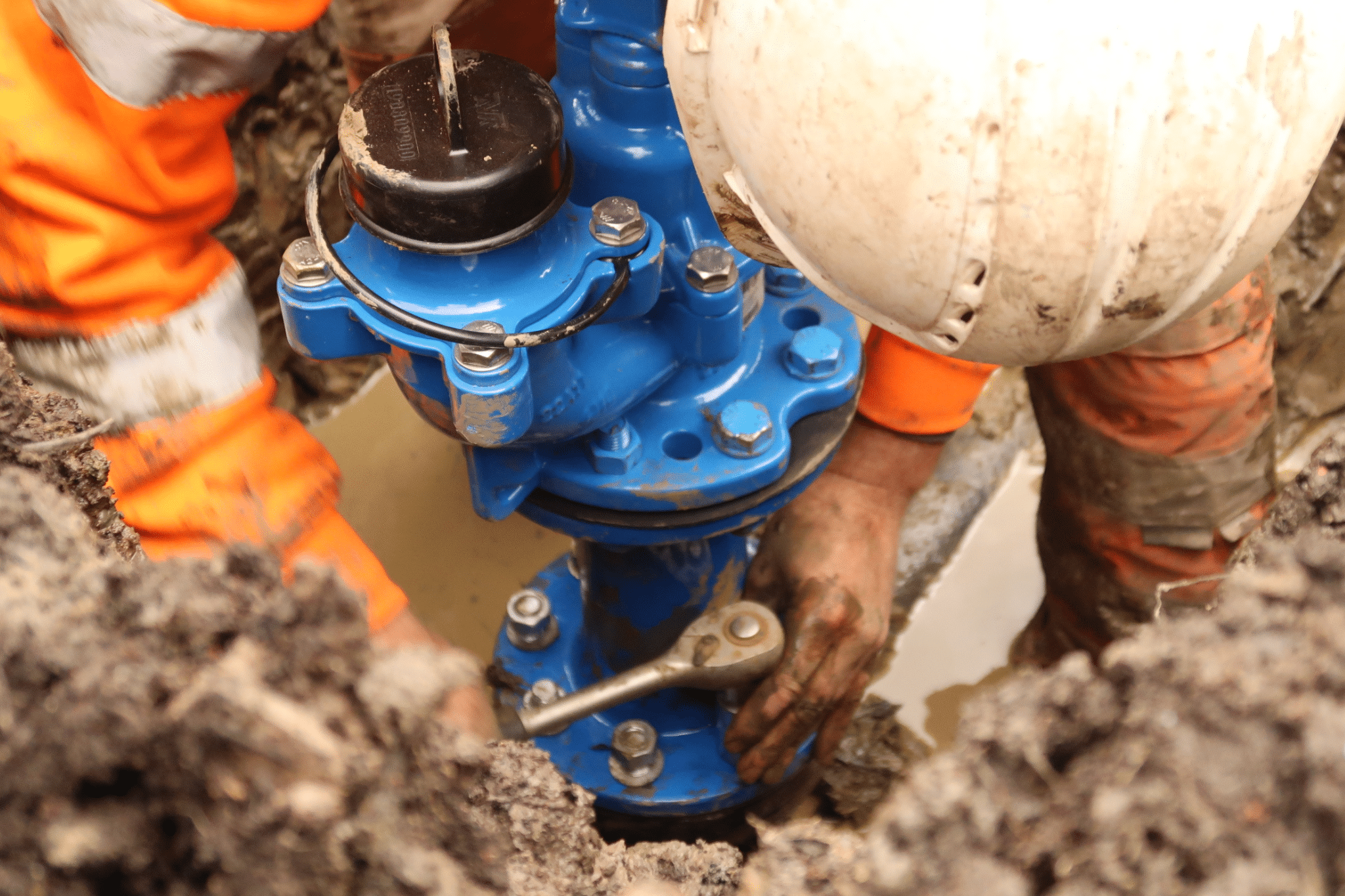 man installing water pipe