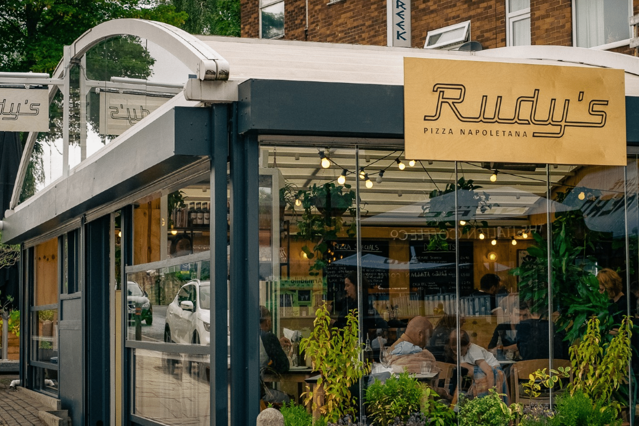 Rudy’s Pizza Leeds city centre shopfront with branded signage and restaurant entrance.