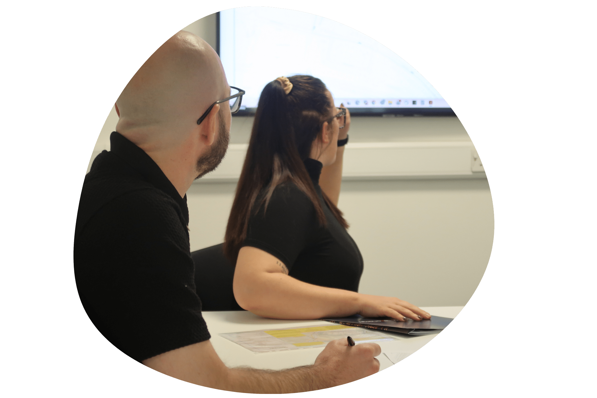 Man and woman pointing at TV screen disucssing accreditations